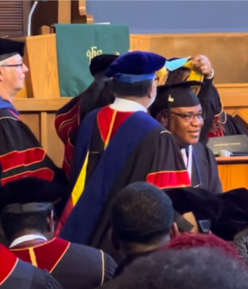 man receiving his masters at graduation