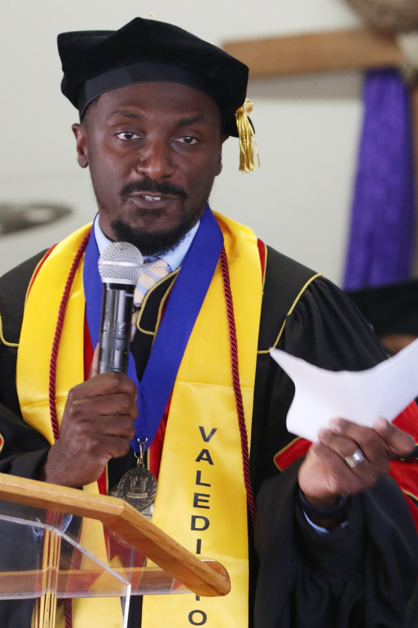 Graduate speaking at podium