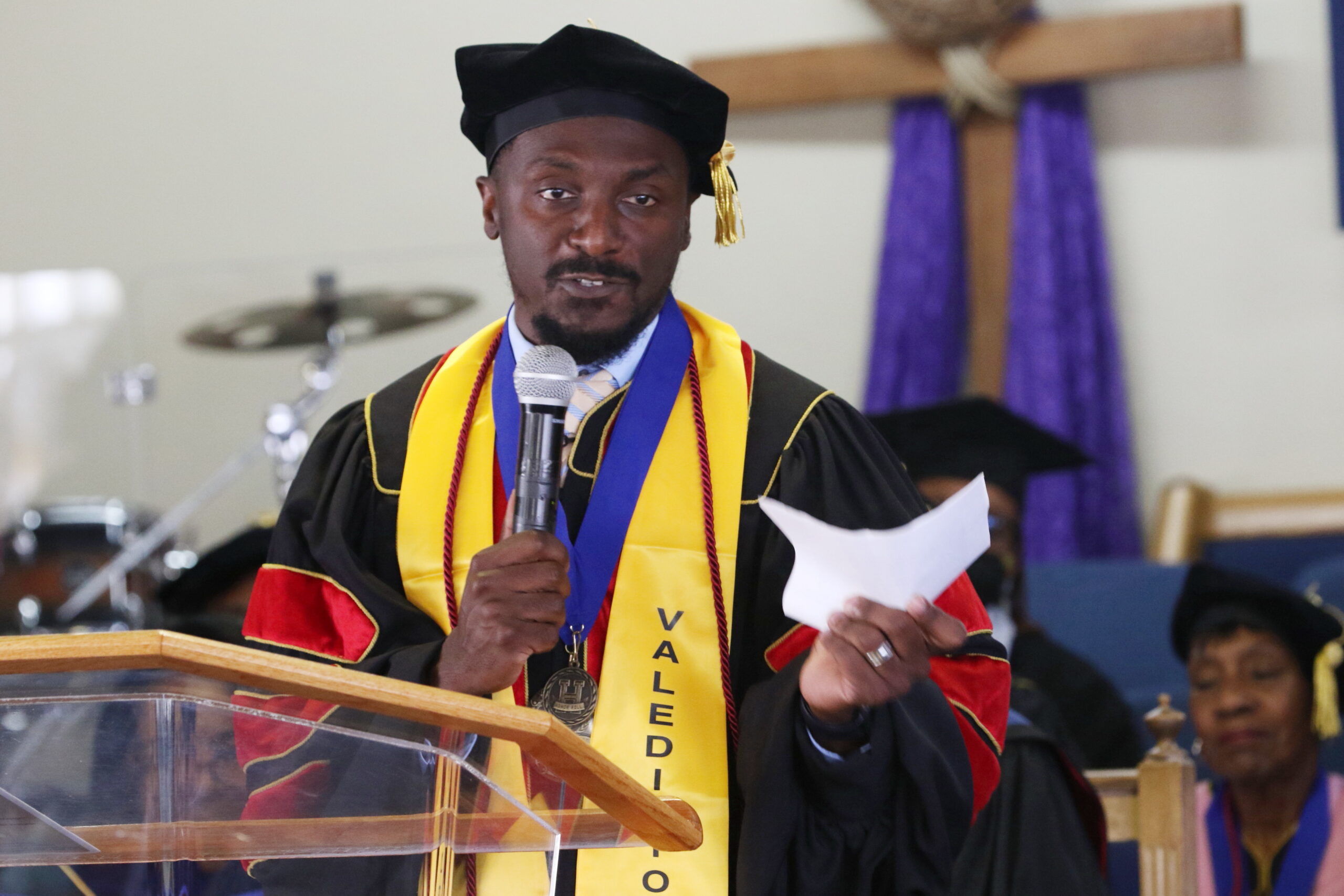 Graduate speaking at podium