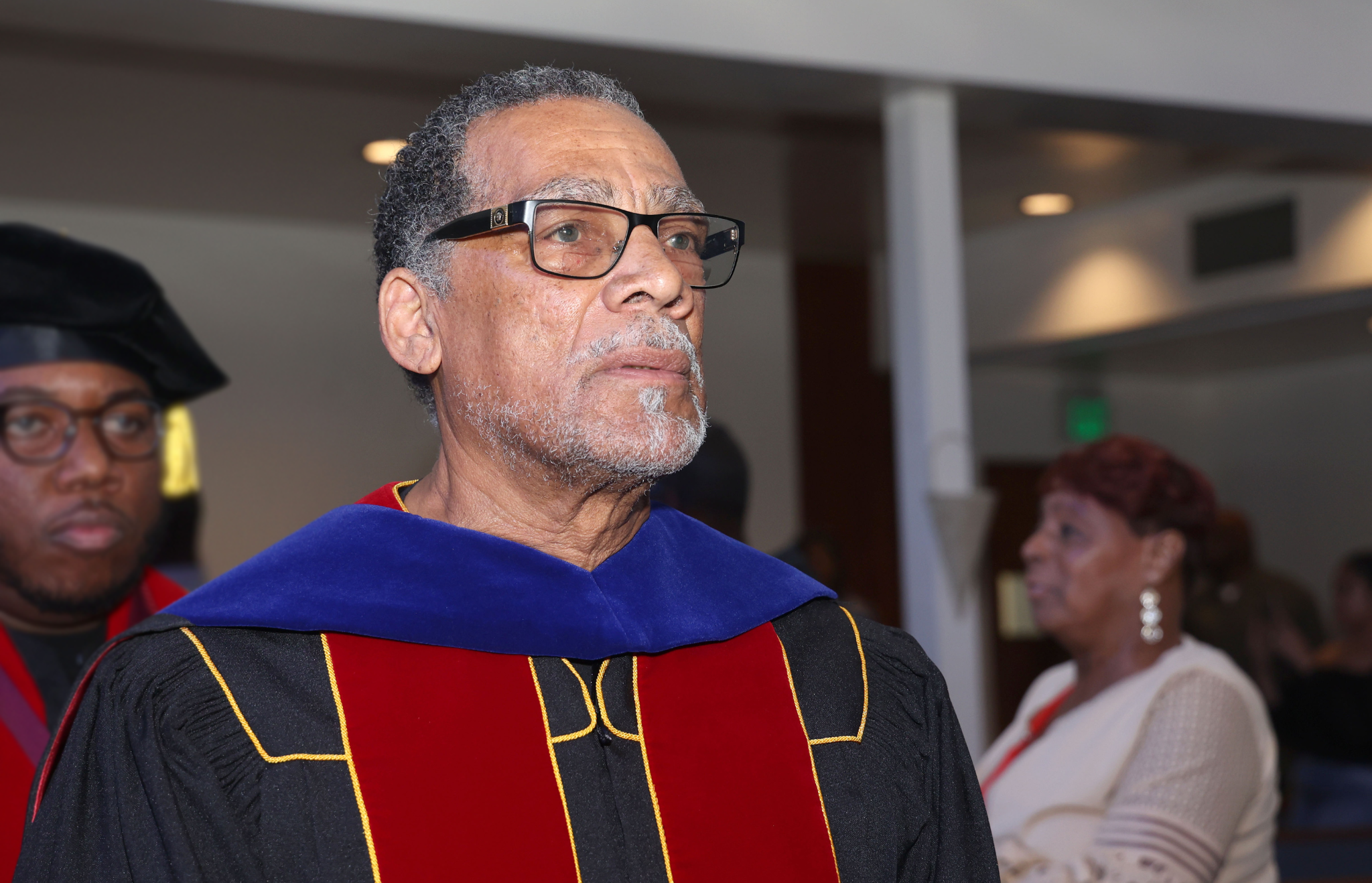 man with doctor of philosophy regalia